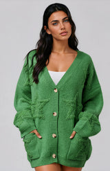 Woman wearing a green cardigan with star print against a grey background