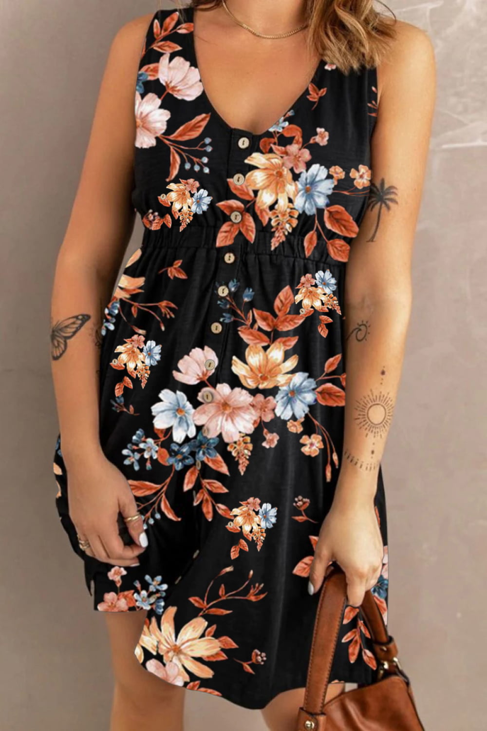 Woman wearing a black floral mini  dress against a neutral background