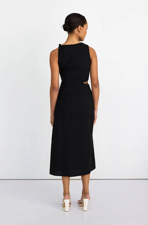 Woman wearing a black dress with cut-out design on a white background