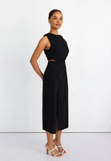 Woman wearing a black sleeveless dress on a white background