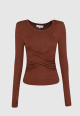 flat lay long sleeve ruched top at the bottom with a wrap cross over waistline w on a white background