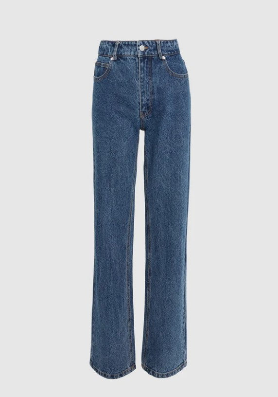 A pair of medium wash blue denim jeans with a straight-leg or wide-leg silhouette, shown against a plain light grey background.
