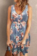Woman wearing a blue floral mini dress against a plain background