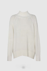 White ribbed turtleneck  sweater on a light grey background