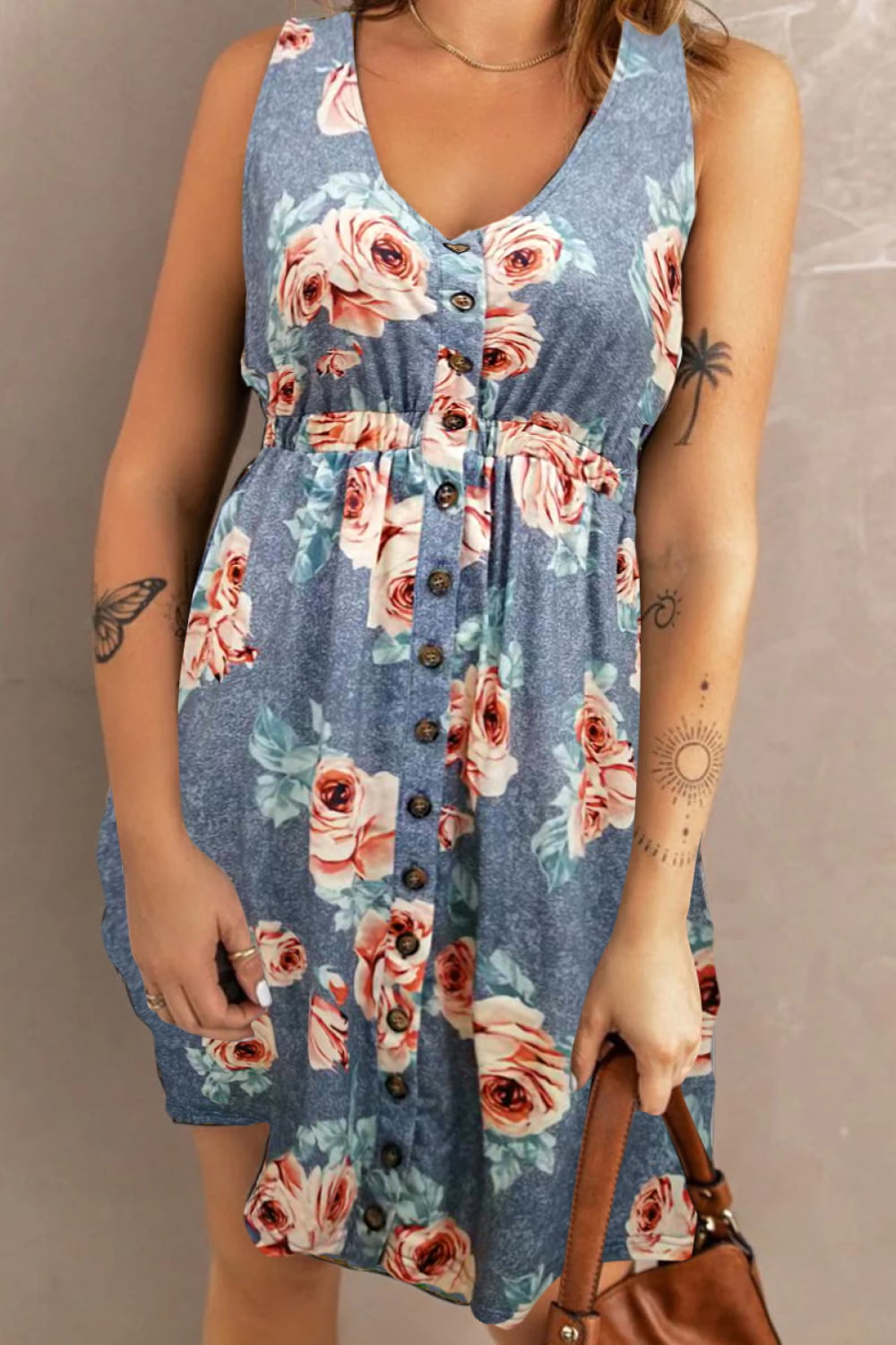 Woman wearing a blue floral mini dress against a neutral background