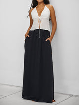 Woman wearing black buttoned maxi skirt with white top
