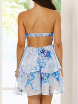 Woman wearing a blue floral dress with a blurred background