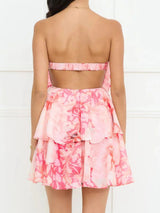 Pink floral dress with cut-out back on a white background
