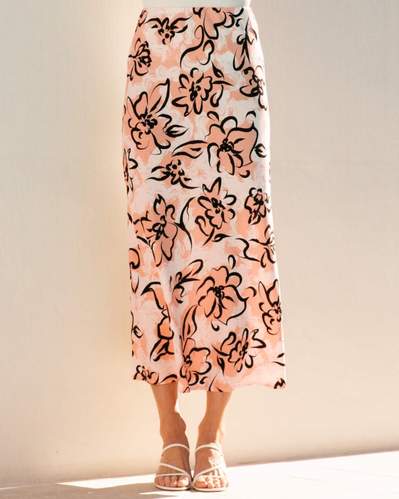 Model walking gracefully in the Angelica Midi Skirt, highlighting the flattering midi length and elasticated waistline.