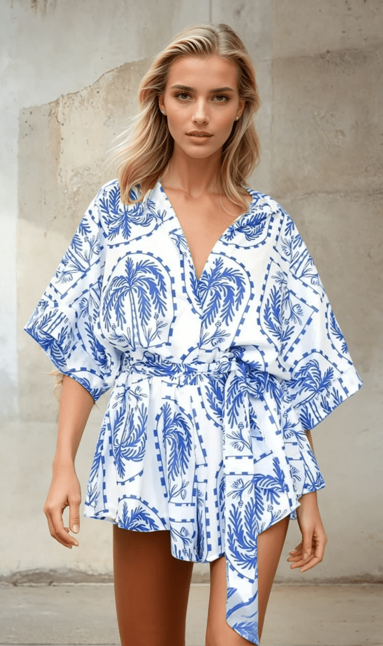 Front view of the Calico Blue Playsuit with button-up shirt design and wide half sleeves.