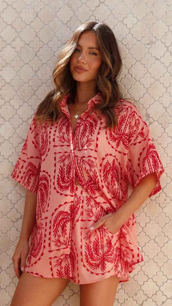 Woman wearing Calico Watermelon Two Piece Set with button-up shirt and shorts.