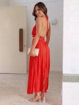 Side view of the Calista Skirt and Top Two Piece Set in red highlighting the flowing pleats.