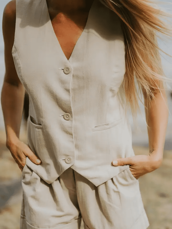Close-up of a model wearing the Cate Shorts in beige, highlighting the tailored waist and side pockets.