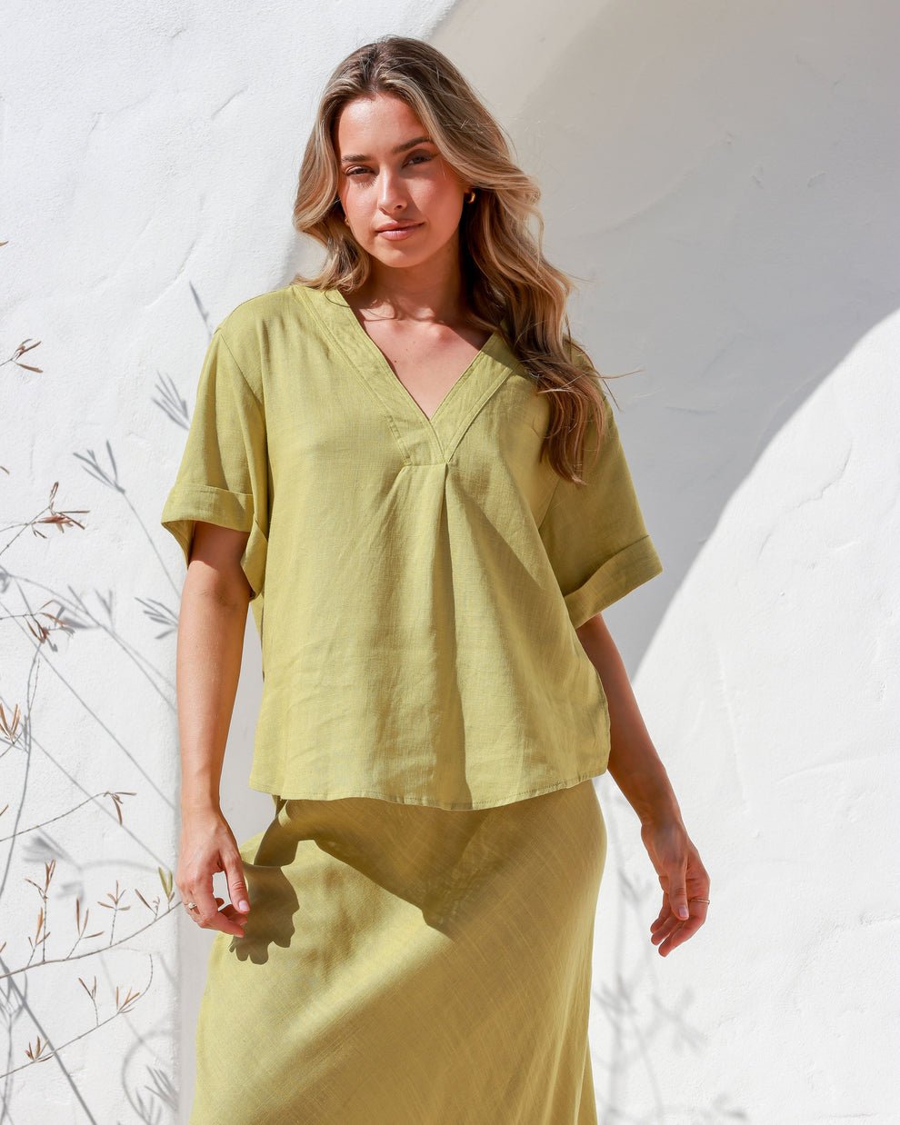 Side view of Label of Love A-Line Skirt with frayed hemline, styled with relaxed fit top