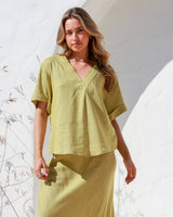 Side view of Label of Love A-Line Skirt with frayed hemline, styled with relaxed fit top