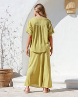 Model walking away showing back view of Label of Love A-Line Skirt in linen blend