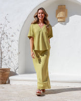 Label of Love A-Line Skirt set in light green with short-sleeve top, model smiling outdoors