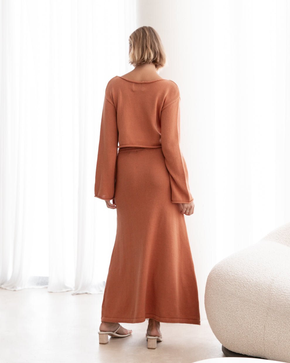Back view of the burnt terracotta Cora Knit Set highlighting the soft drape and flattering cut.