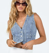 Denim Vibing Me Vest worn open with white skirt and gold accessories.