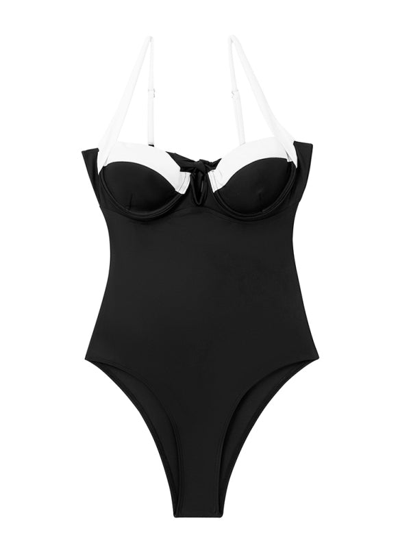 Flat lay of the Ebony One Piece Swimsuit in black with white straps.