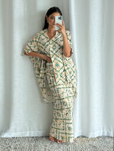 Model takes a mirror selfie in profile view, emphasizing the skirt's flow and the relaxed silhouette of the shirt.