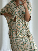 Front-facing mirror selfie highlighting the waist tie and print of the Echo Slip Skirt with matching top.