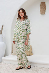 Model styling slip skirt with relaxed pose outdoors.