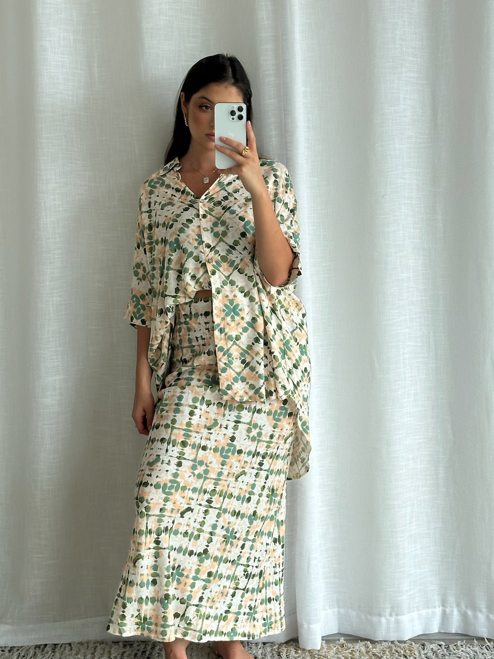 Mirror selfie of the Echo Slip Skirt and top styled together, offering an at-home try-on vibe with curtains as background.