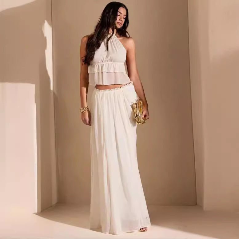 Woman wearing the Eden Two Piece Set in creamy white, standing in a sunlit studio