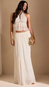 Side profile of woman holding a gold clutch, styled in the Eden Set