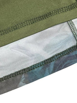 Close-up of a green, gray, and blue fabric with stitching detail on a white background