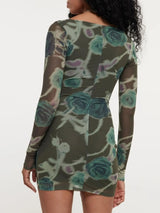 Woman wearing a floral dress with long sleeves on a white background