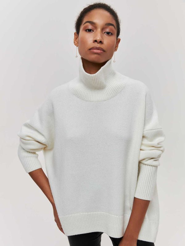 Front-facing view of the White Falling For You Sweater styled with black pants.