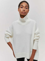 Front-facing view of the White Falling For You Sweater styled with black pants.