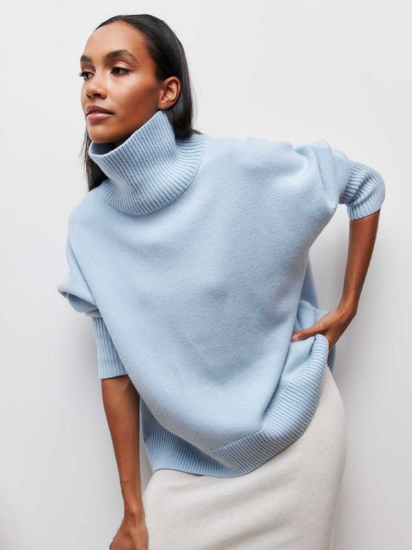 Woman wearing the Falling For You Sweater in Sky Blue with soft turtleneck and white skirt.