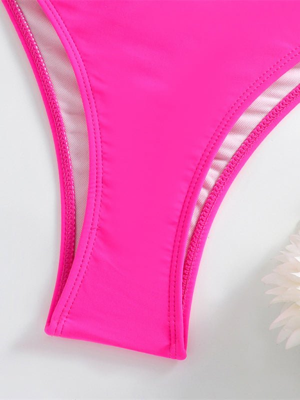Close-up of a bright pink bikini bottom on a light gray background