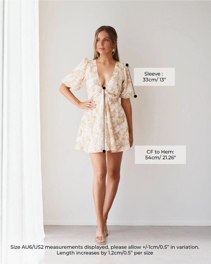 Fion Mini Dress front view with size chart overlay, showcasing fit and styling.