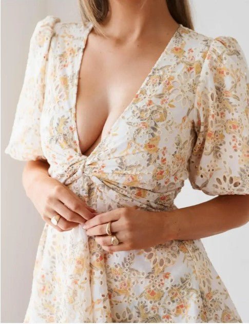 Close-up of Fion Mini Dress showing puff sleeves, V-neckline, and floral detail.