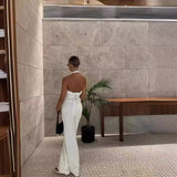 Back view showing tie detail and dramatic open back of the white top