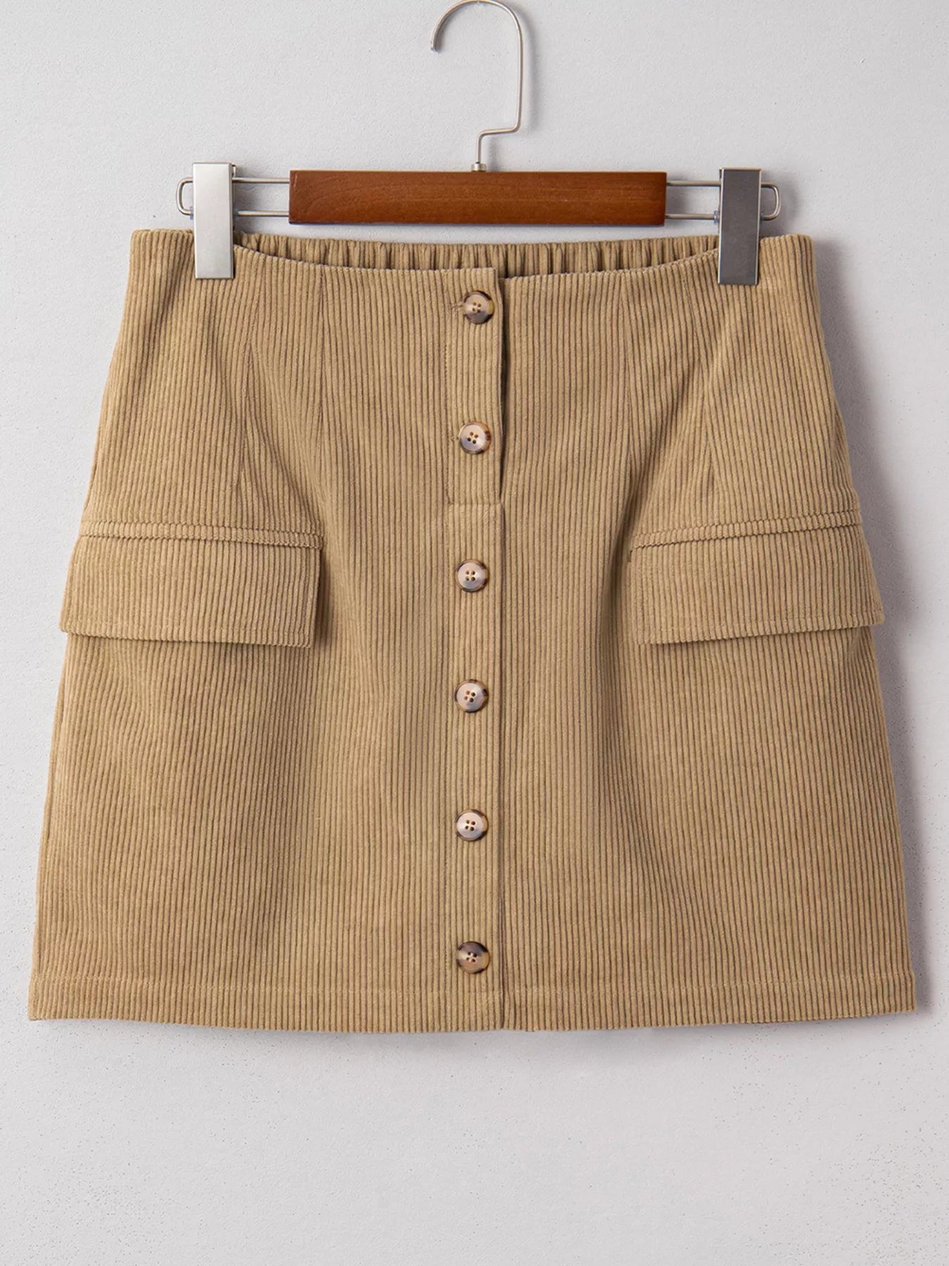 Front view of tan corduroy mini skirt on hanger