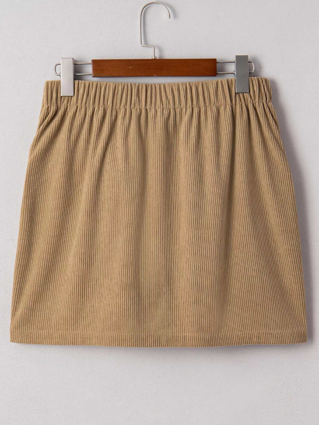 Back view of tan corduroy mini skirt with elastic waistband