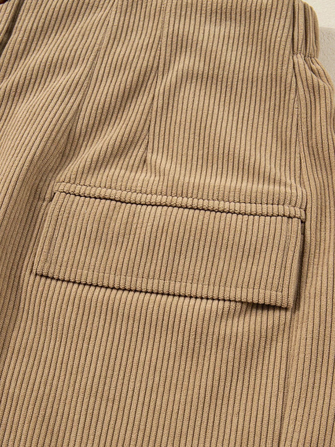 Close-up of brown buttons on corduroy fabric