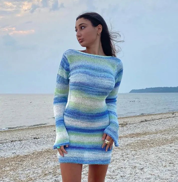 Woman wearing a blue and green striped sweater on a beach
