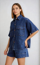Side angle of the denim two piece set showing the collared shirt’s structure and chest pockets.