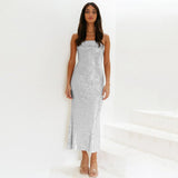 Woman wearing a silver sequin dress against a white background