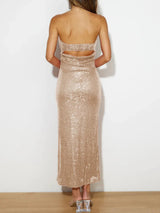 Gold sequin dress worn by a person on a white background