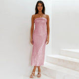 Woman wearing a pink strapless dress against a white background