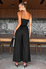 Leela Wide Leg Jumpsuit in Black, back view with delicate strap and zipper detail