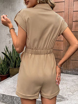 Back view of model wearing The Leonila Playsuit in camel, showcasing ruched waist detail.