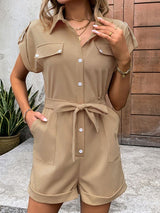 Front full view of The Leonila Playsuit in camel, styled with sandals and accessories.